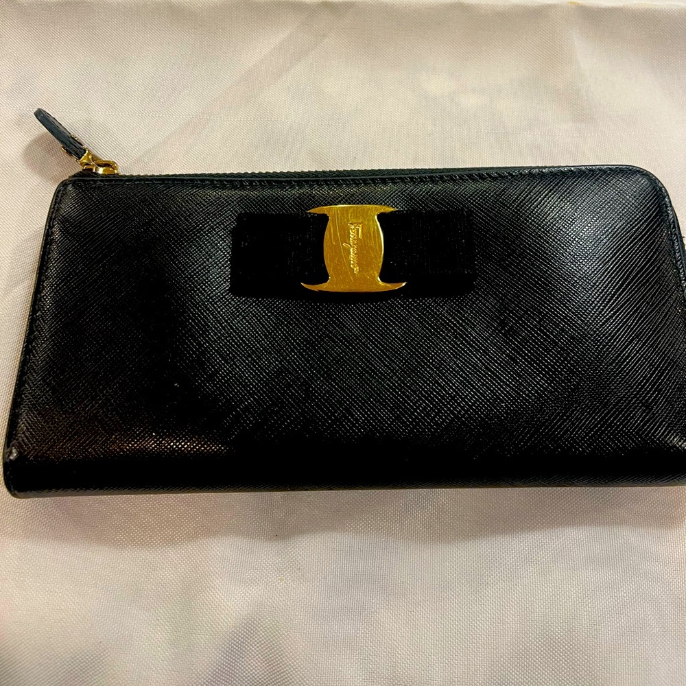 Salvatore Ferragamo leather zip around wallet with 8 credit card slots.